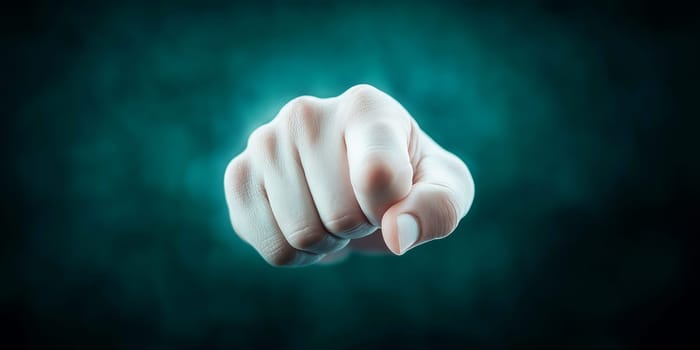 A clenched fist, pointing directly at the viewer. Unclear context, but likely conveying a message of determination or challenge.