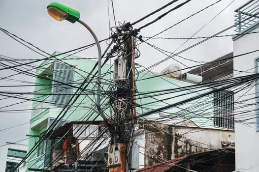 mess in the electricity wires on the street in a city in Asia in Vietnam