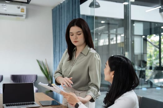 A team of financial professionals reviews reports and discusses budgeting strategies in a collaborative workspace.
