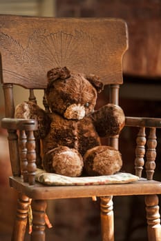 Teddy bear sitting in a chair.