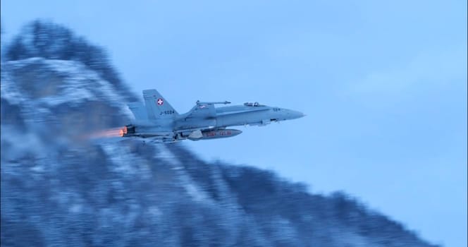 Meiringen Switzerland January 19, 2023: Swiss F-18 Hornet taking off from a snow-covered airfield during security patrols for the World Economic Forum in Davos. Military readiness. Copy space