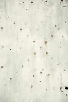 A textured close-up of a weathered metal surface with rusted rivets and signs of aging. Ideal for industrial, grunge, and vintage design backgrounds