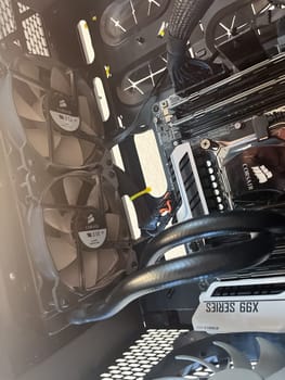 Castle Rock, Colorado, USA-August 18, 2024-A custom built gaming PC with an open side panel revealing internal components The build features a Radeon graphics card liquid cooling system multiple storage bays and a high performance power supply The black case has ample ventilation and cable management for optimal airflow Ideal for gaming enthusiasts and PC builders