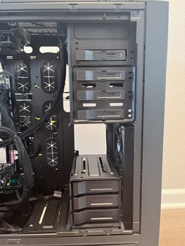 Castle Rock, Colorado, USA-August 18, 2024-A custom built gaming PC with an open side panel revealing internal components The build features a Radeon graphics card liquid cooling system multiple storage bays and a high performance power supply The black case has ample ventilation and cable management for optimal airflow Ideal for gaming enthusiasts and PC builders