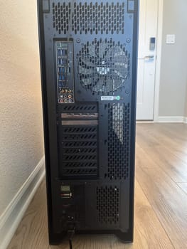 Castle Rock, Colorado, USA-August 18, 2024-A custom built gaming PC with an open side panel revealing internal components The build features a Radeon graphics card liquid cooling system multiple storage bays and a high performance power supply The black case has ample ventilation and cable management for optimal airflow Ideal for gaming enthusiasts and PC builders