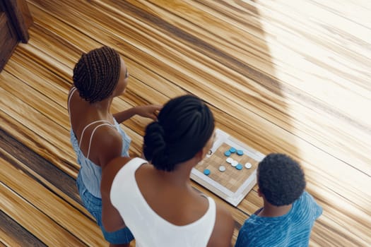 A family is happily enjoying quality time together while playing an engaging board game on a wooden floor