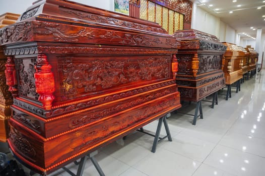wooden coffins with traditional Asian ornament pattern in a funeral home in Asia