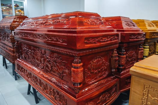 wooden coffins with traditional Asian ornament in a funeral home in Asia in Vietnam