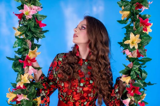 In a colorful setting, a stunning model poses with beautiful floral decor, highlighting her sophistication