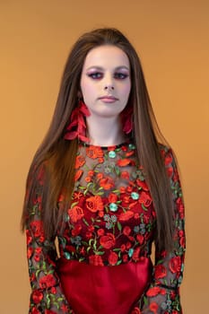 A captivating and striking portrait showcasing a young model adorned in a floral dress and statement earrings