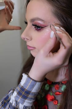A highly skilled professional makeup artist enhances a clients look beautifully with intricate detailing techniques