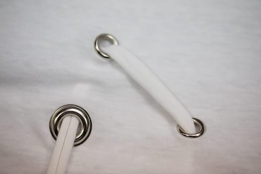 This is a detailed view showcasing grommets, along with white rope utilized in various fabric applications