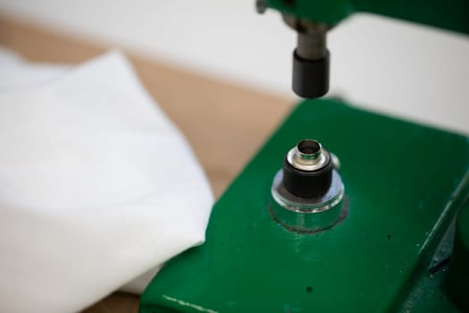 A closeup view of a vibrant green fabric press machine that is utilized for both crafting and sewing purposes