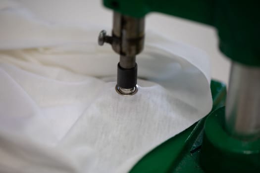 This is a detailed view of a sewing machine tool that expertly attaches fabric with great precision and care