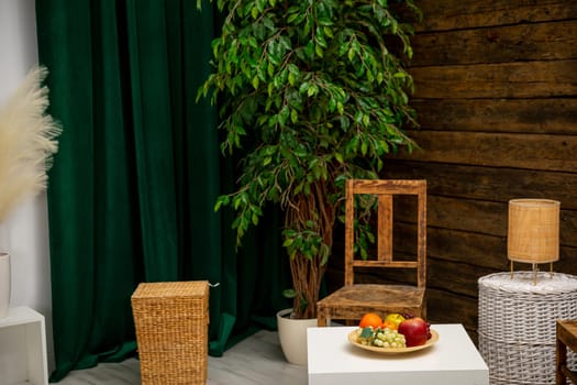 A serene setup with a green backdrop, stylish wooden furniture, and a colorful array of fresh fruits