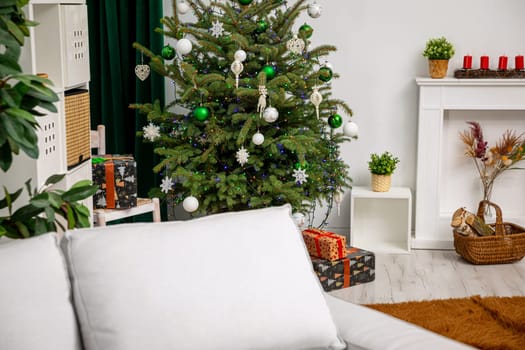 A beautifully festive living room, featuring an elegantly decorated Christmas tree alongside cozy holiday decor