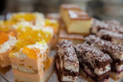 A tempting display of stunning layered cakes and sweet treats, ideal for any celebration or gathering
