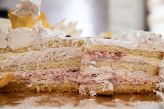 A beautiful close-up of a layered cake featuring cream and berry layers, perfect for dessert lovers.