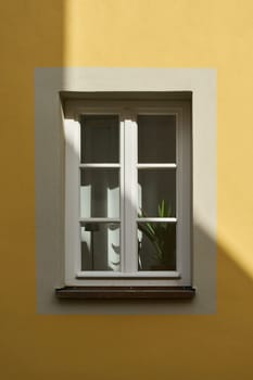 single window on the facade of a yellow house in Rothenburg ob der Tauber in Germany