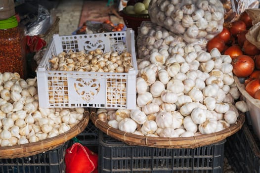 stall with garlic and onions at a street vegetable grocery market