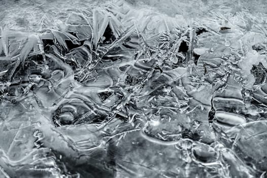 Frozen stream and ice closeup photo. Beautiful winter abstract background in nature. Concept for water and winter time