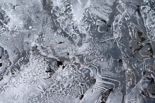 Frozen stream and ice closeup photo. Beautiful winter abstract background in nature. Concept for water and winter time