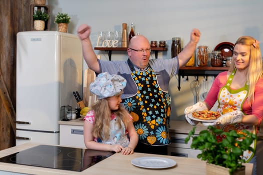 A joyful and cheerful family happily engages in cooking together, showcasing their creativity and unity in the kitchen
