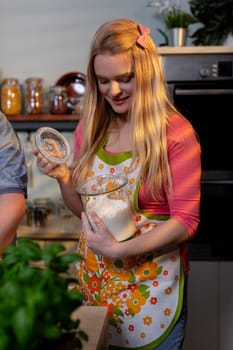 A cheerful woman joyfully cooks in a vibrant kitchen, showcasing her passion for making delicious food