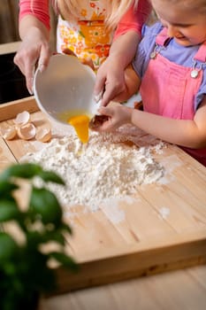 A truly joyful and delightful moment shared between a parent and their child while baking together using flour and eggs