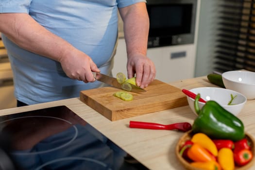 A skilled individual expertly chopping vibrant, fresh vegetables in a modern kitchen setting, filled with style