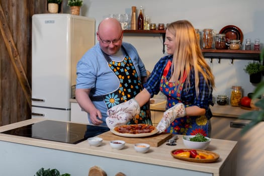 A delightful and joyful cooking scene featuring two people joyfully preparing delicious food together as a team