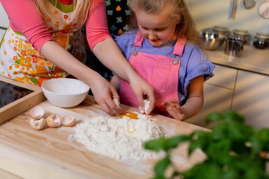 A heartwarming and delightful scene of a loving parent and their child joyfully preparing dough in the kitchen together