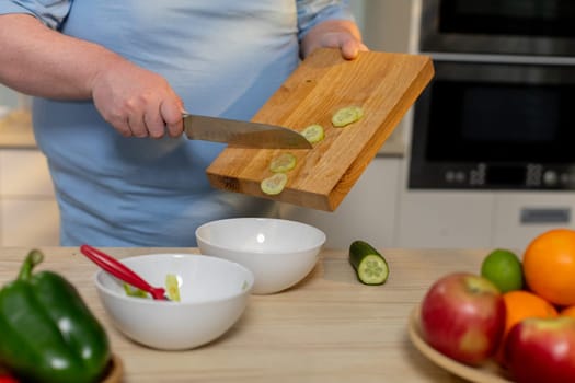 A person skillfully chopping fresh vegetables in a stylish and modern kitchen, showcasing healthy meal preparation