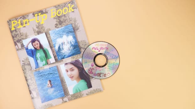 K-pop group NewJeans Album photobook on yellow. Music CD player. South Korean girl group NewJeans. Space for text. Gatineau, QC Canada - March 16 2024
