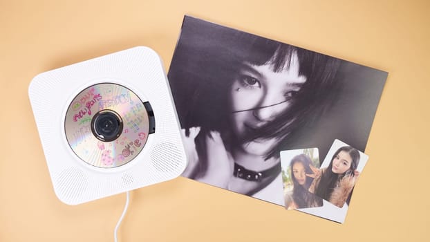 K-pop group NewJeans Album photobook on yellow. Music CD player. South Korean girl group NewJeans. Space for text. Gatineau, QC Canada - March 16 2024