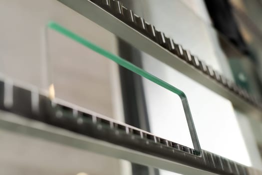 Closeup part of glass cut and polished machine with metal and plastic elements