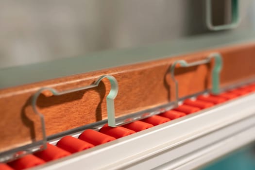 Closeup detail of glass cut and polished machine with rollers on metal rack