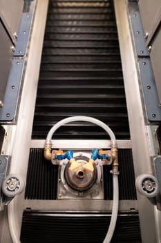 From above of professional equipment with tubes near wheels and screws over rubber elements