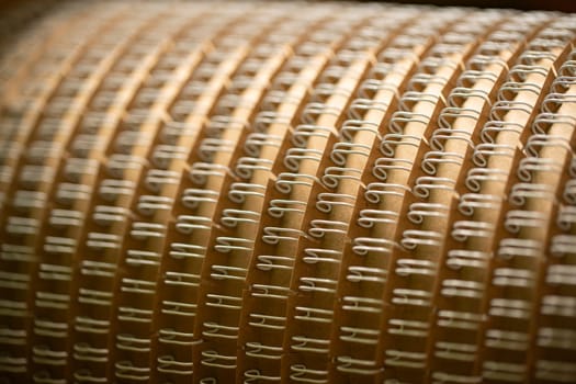 Rounded detail for professional machine tool with identical spirals for paper notebooks in workshop