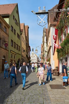 Rothenburg ob der Tauber, Germany – September 22, 2024: Tourists in the obere Schmiedgasse in the old town of Rothenburg ob der Tauber in Germany