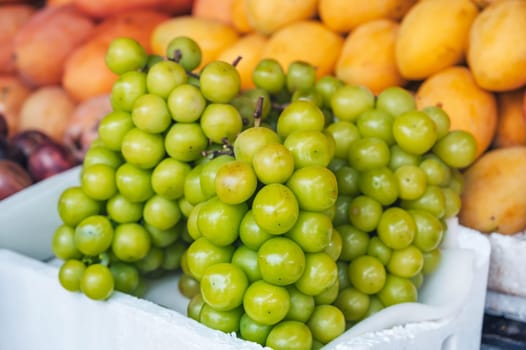 bunch of green Korean grape Shine Muscat on the counter at the market in Asia