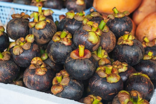 harvest of ripe mangosteen at a market in Asia in Thailand close-up