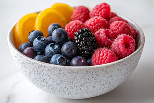 A vibrant bowl filled with fresh blueberries, raspberries, blackberries, and sliced peaches showcases a healthy dessert option.