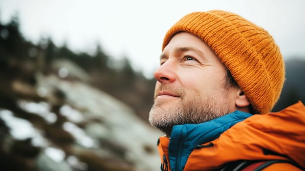 Travel, hiking, adventure, close-up portrait of happy traveler hiker man in hat stands on top of mountain looking away, side view
