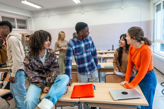 Multi ethnic university students engaging in lively conversation after class, creating connections and sharing ideas in a bright classroom setting