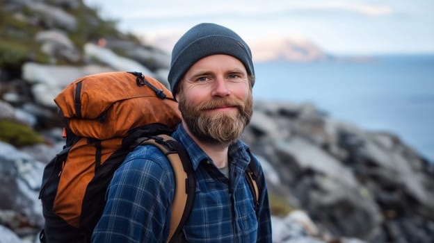 Travel, hiking, adventure, portrait of traveler hiker bearded man stands on mountain coast looking at camera