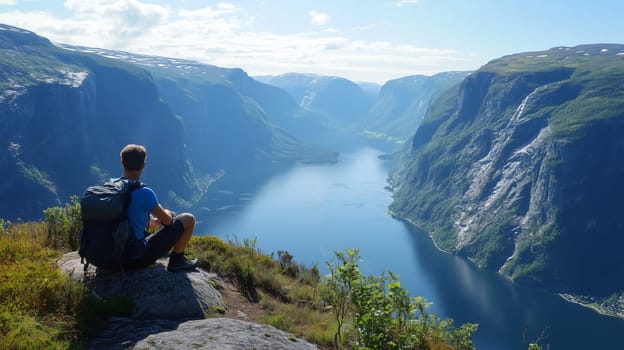 Travel, hiking, adventure, back view of inspired traveler hiker man sitting on top of winter mountain looking at scenic range with river