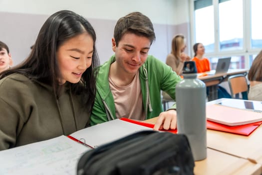 Two high school students are working together on a project in a classroom, demonstrating teamwork and collaboration in education
