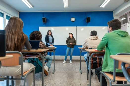 Confident young woman giving a presentation to her classmates and teacher in a modern university classroom