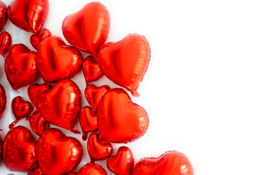 frame for text made of foil balloons in the shape of hearts. balloons of various sizes from large to small hearts. balloons are located on the left side of the background. horizontal